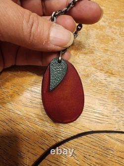 Vintage Hermès leather plum fruit bag charm and keychain featuring burgundy box